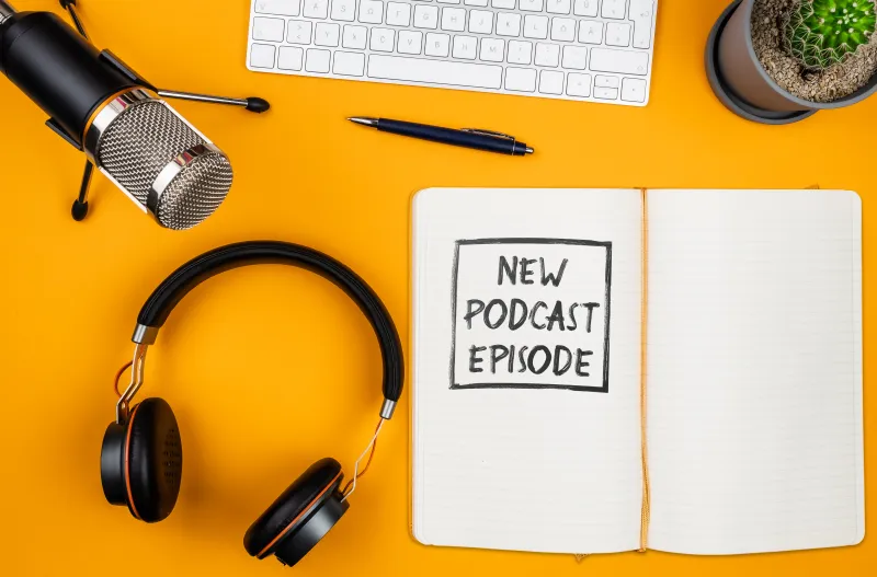 writing podcast names on notebook posted by Podpacer